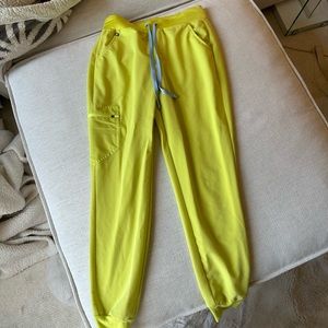 Figs yellow scrub bottoms. Size S. With blue tie strings.